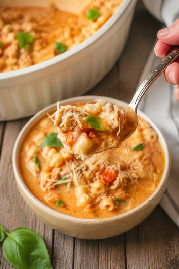 Ditalini pasta cooking in tomato and chicken broth
