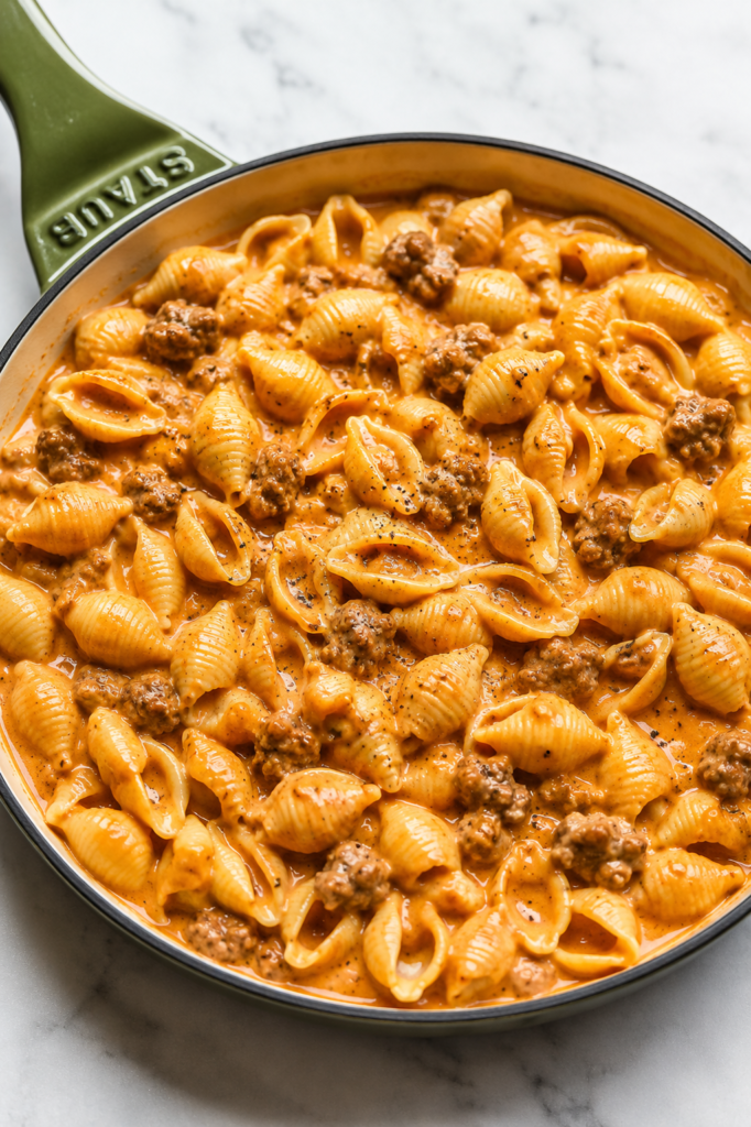 Pasta shells simmering in beefy tomato sauce