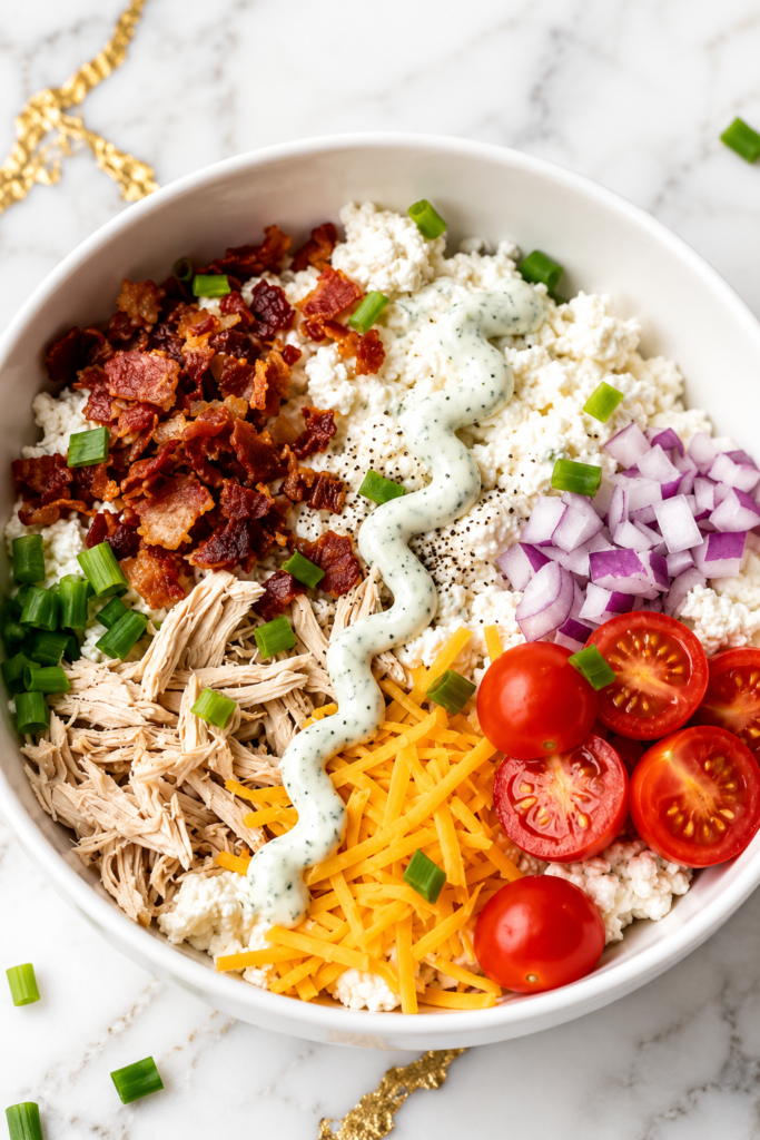 Finished chicken bacon ranch cottage cheese bowl with cheddar and chives