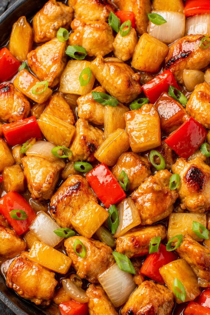 Pineapple chicken served over rice with sesame seeds