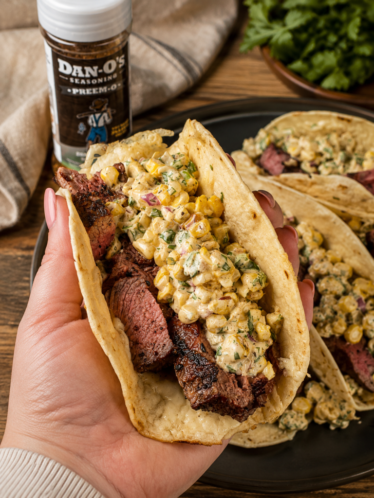 Grilled steak elote tacos with lime wedges