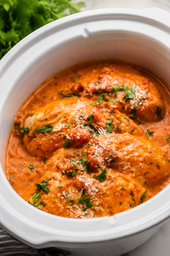 Cream and parmesan stirred into tomato sauce in a slow cooker