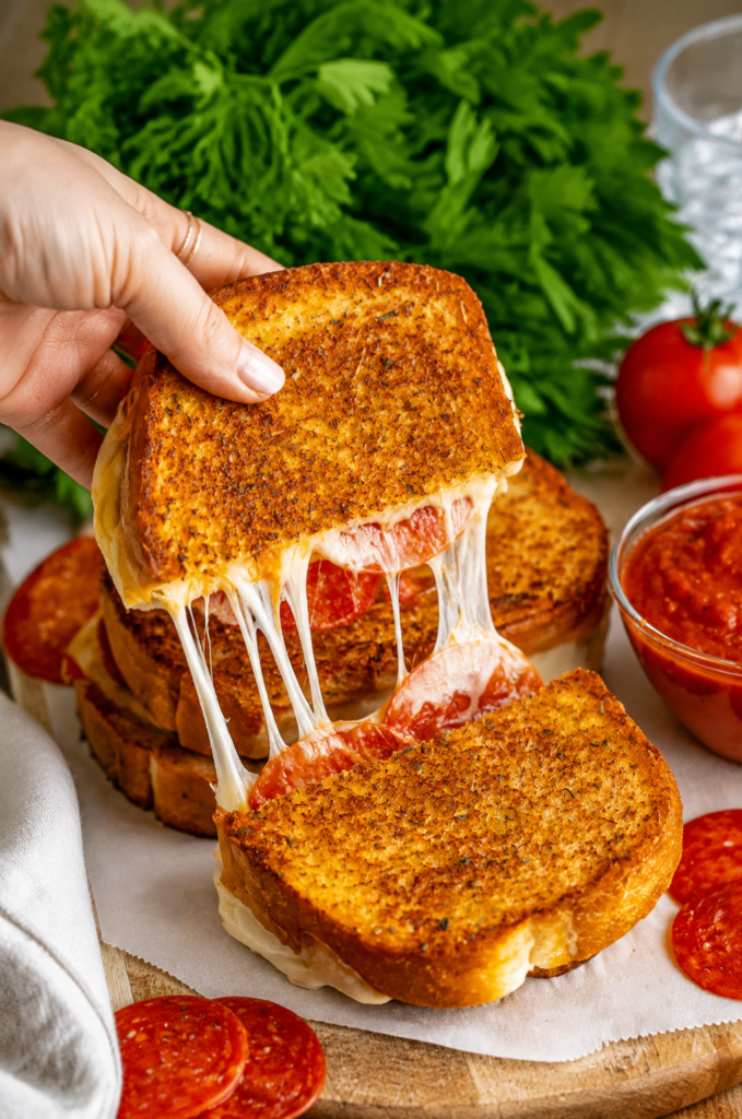 Pizza grilled cheese cooking under a lid in a skillet