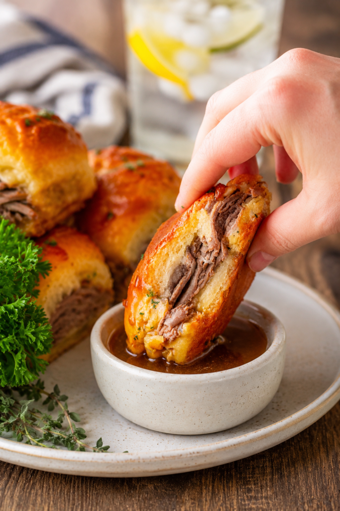 French dip sliders served with a cup of au jus