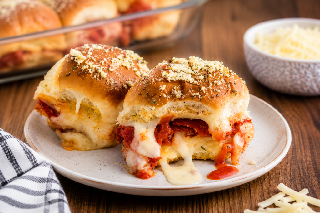Pizza sliders sliced apart with melted cheese