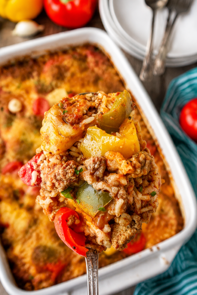 Casserole mixture topped with marinara and cheese in a baking dish