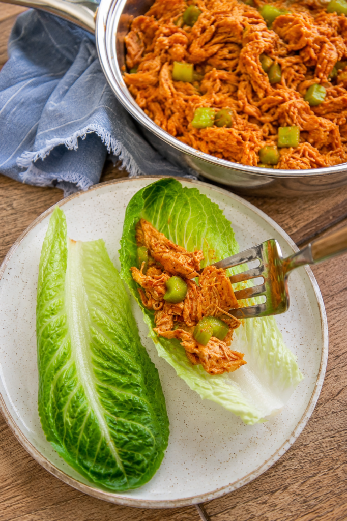 Finished buffalo chicken lettuce wraps drizzled with ranch
