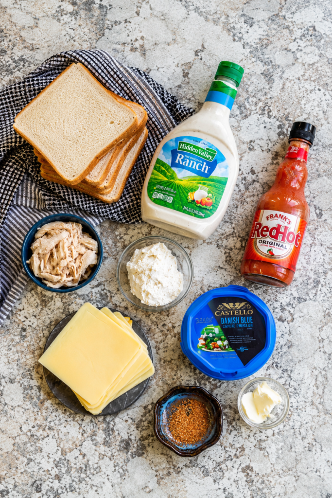 Cream cheese and blue cheese mashed together in a bowl