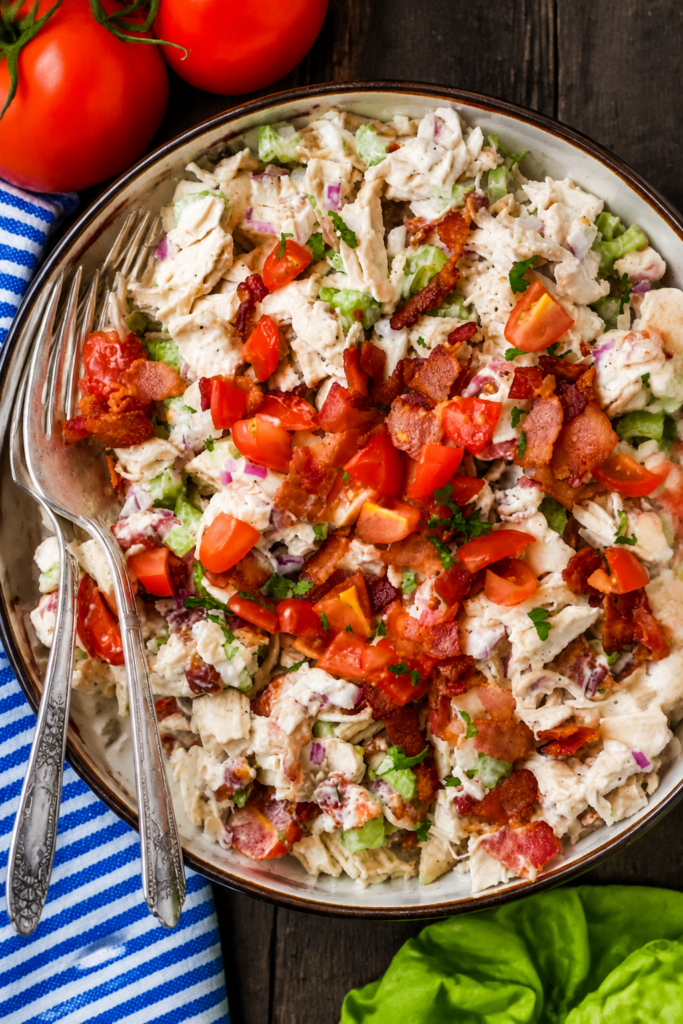 Chicken, bacon, tomatoes, and celery combined in a bowl