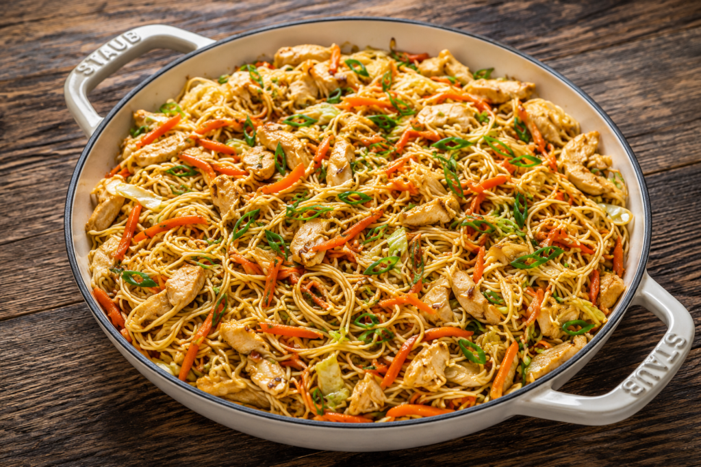Finished chicken chow mein garnished with green onions