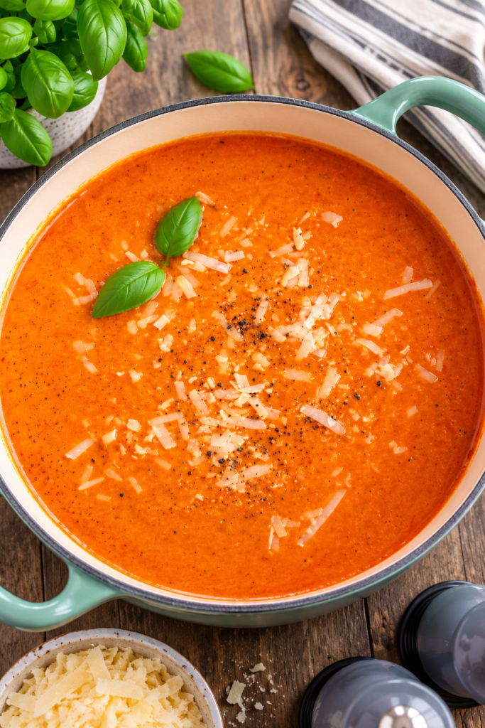Canned tomatoes and broth simmering in a covered pot